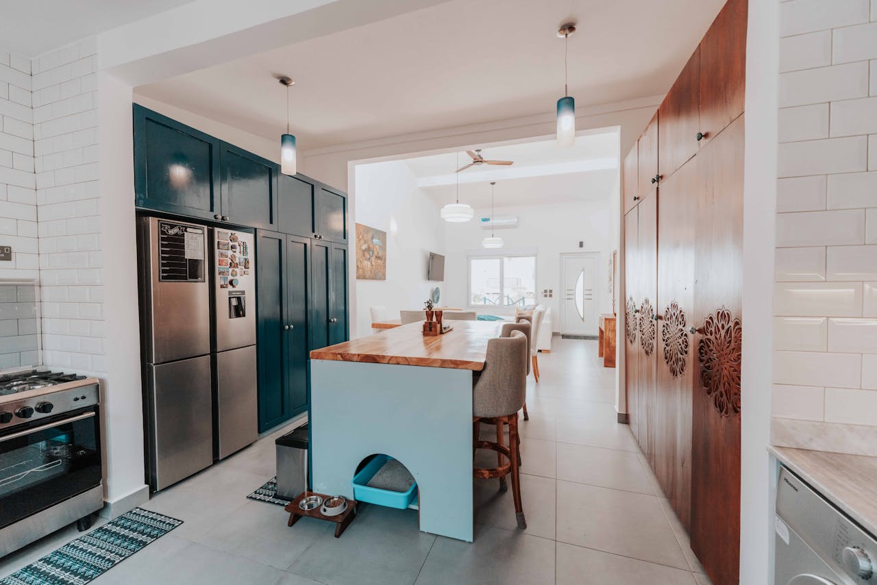 about-img Spacious and stylish kitchen featuring a central island and modern design elements.