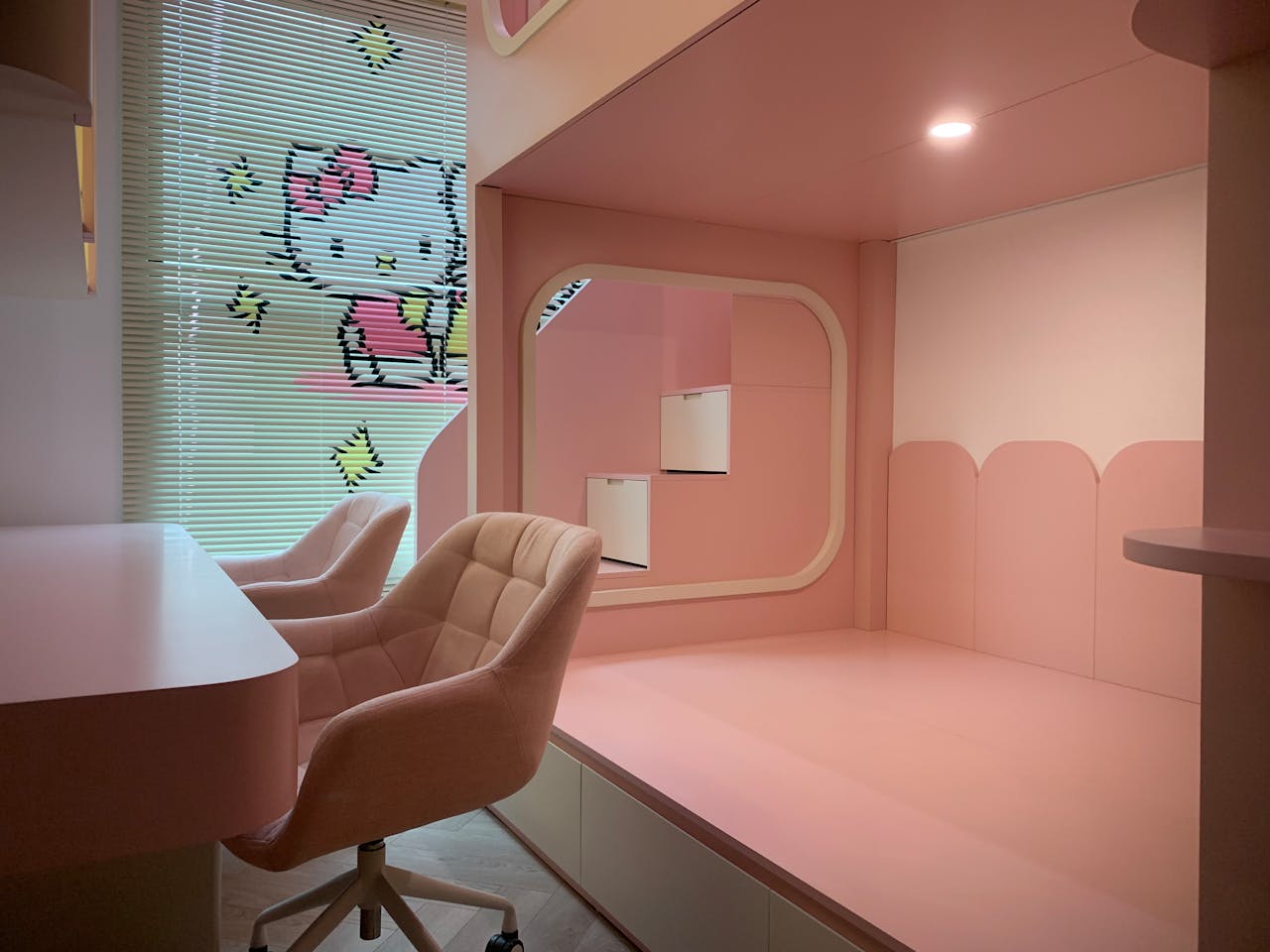 services-04 Cute pink-themed interior design with chairs and Hello Kitty motif.