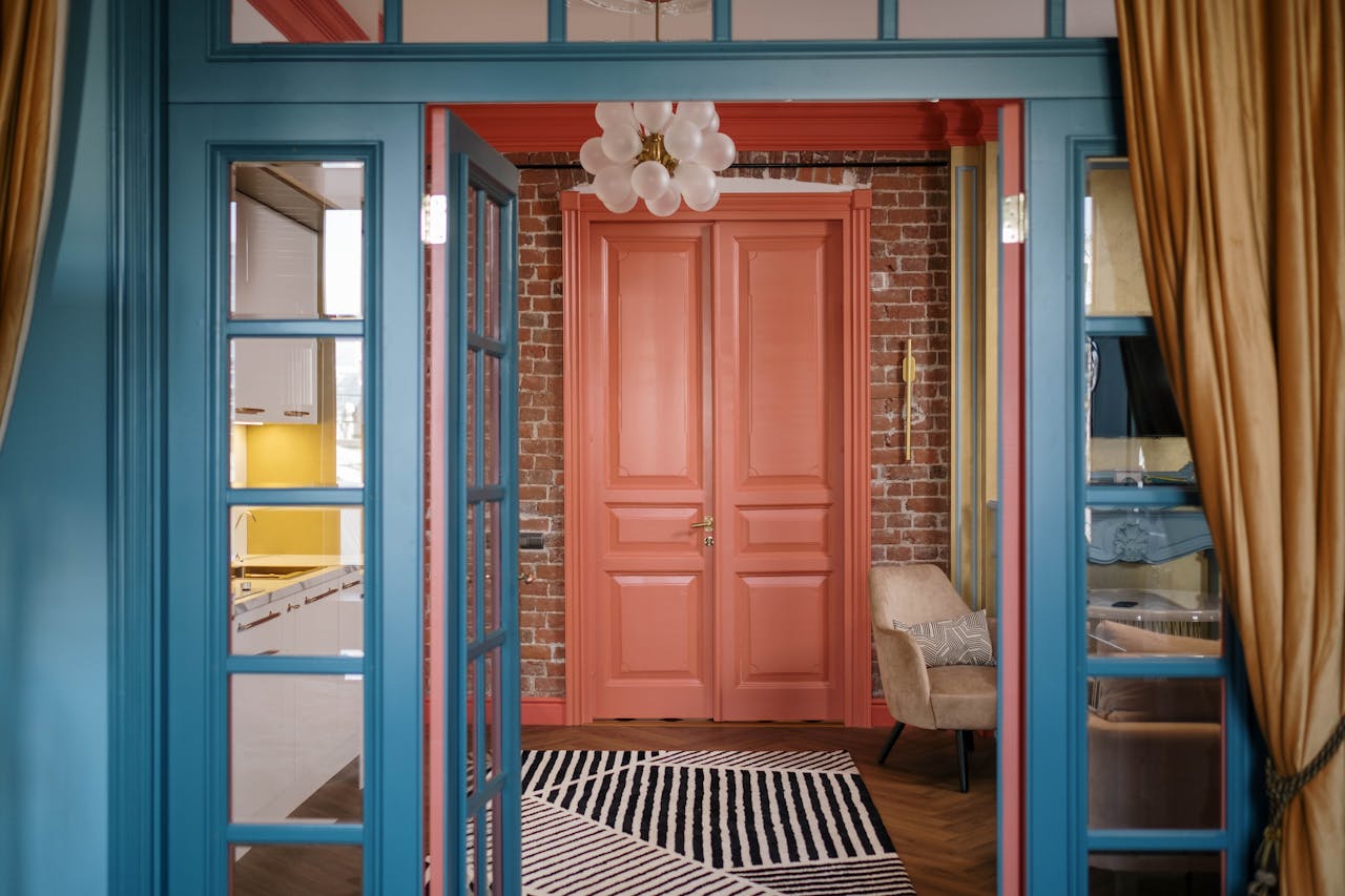 services-img A stylish interior featuring bright blue and red doors with brick walls and modern decorations.