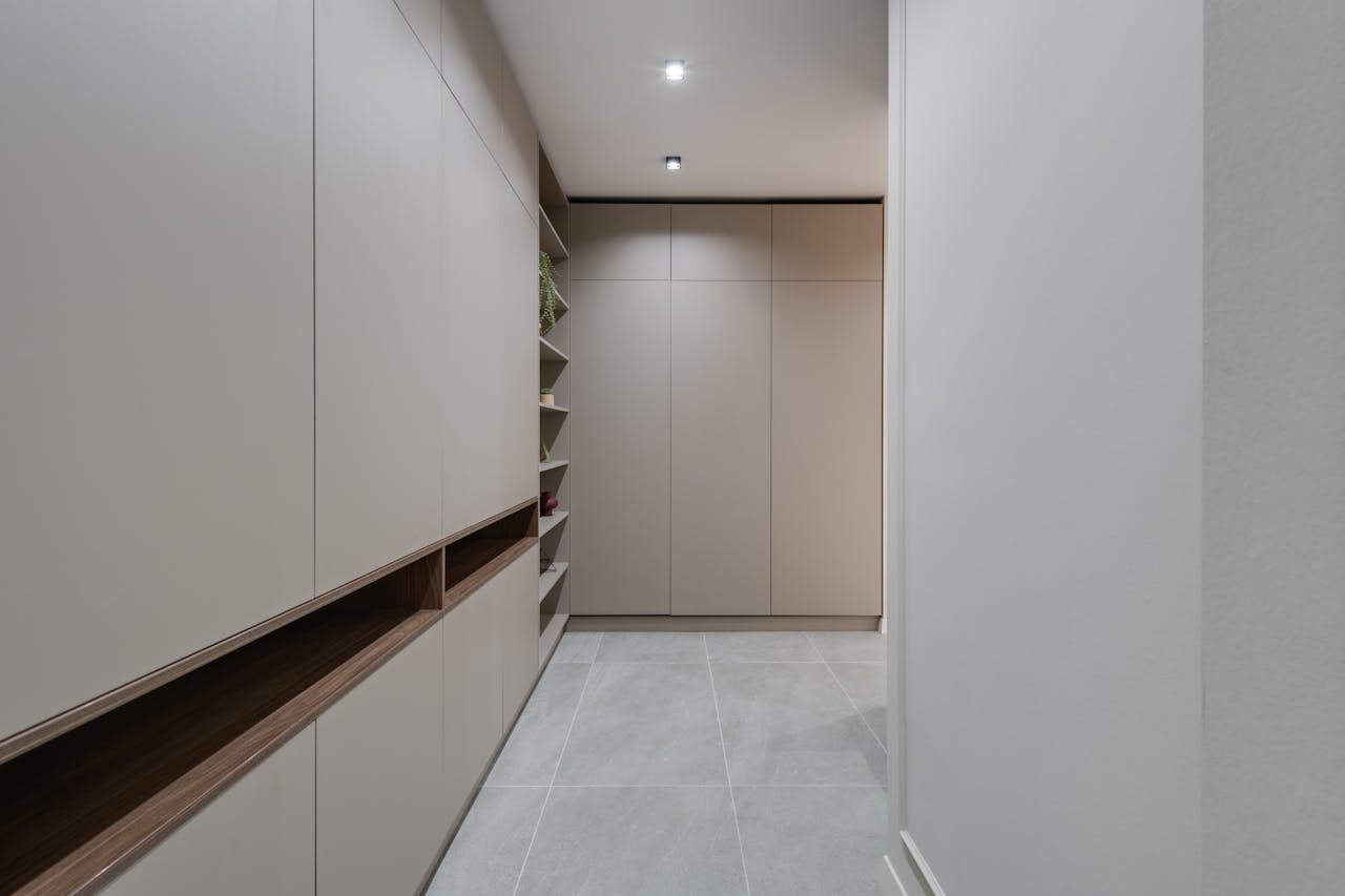 Explore a contemporary minimalist hallway featuring sleek modern cabinetry and neutral colors.